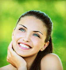 Woman showing off her beautiful dental crown in Juno Beach